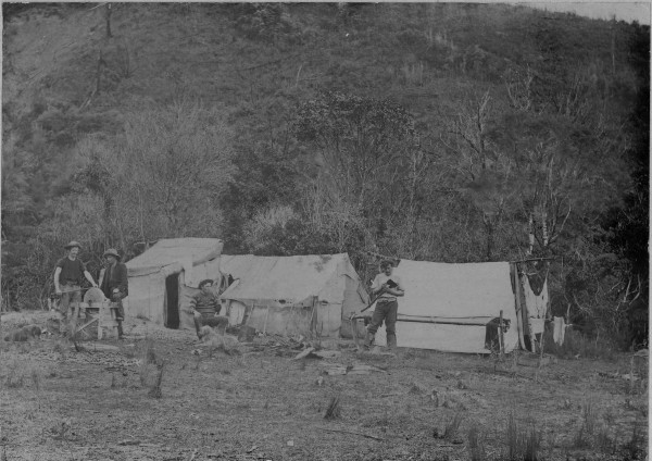 Three tents in Momorangi Bay with four men outside. 