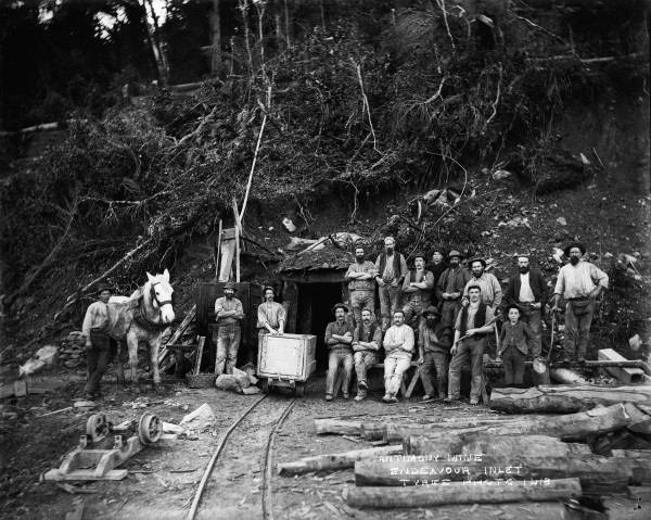 Entrance way to antimony mine. Men and horses outside. 